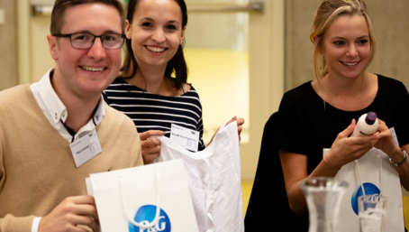 Group of students shows the contents of a bag with advertisements