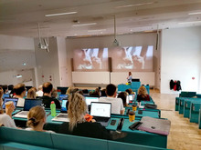 students in the auditorium, looking at Nespresso's presentation