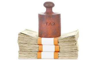 a weight with the word tax on it, pressing down on bundles of money