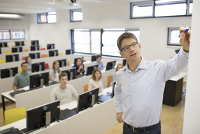 Teaching Setting with a group of students and a professor.