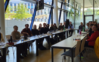 People sitting together around a U-shaped table
