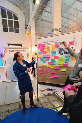 people discussing in front of a white board