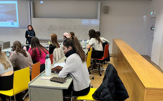 Students in the classroom listening to Professor Hartl