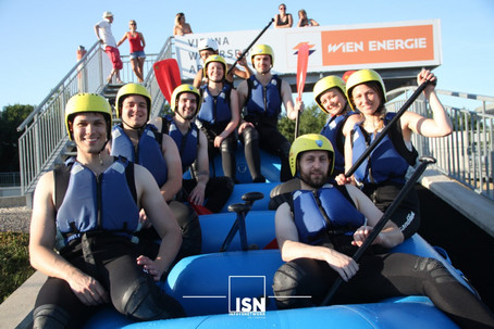 Group of young people in a rafting boat.