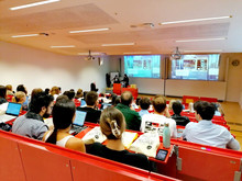 students in the auditorium, looking at felzl's presentation