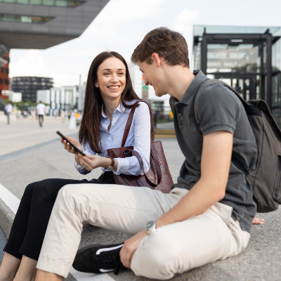 Two students sitting on WU Campus talking.