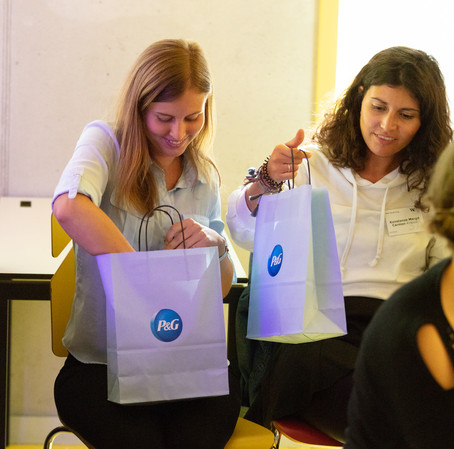 The lucky Marketing Master students peeking in their P&G goodie bags.