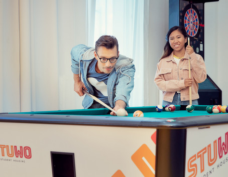 STUWO apartment. Here, we see students playing pool.