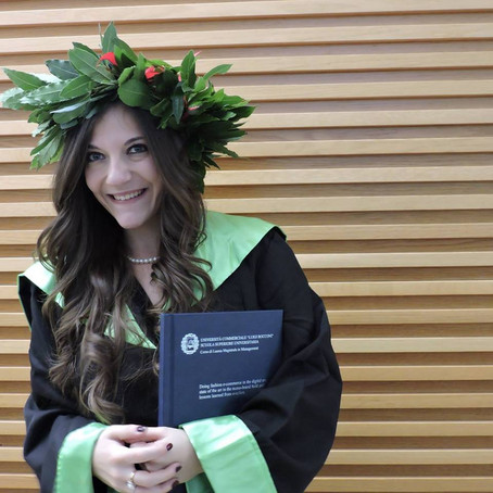 Young graduate with laurel wreath and certificate