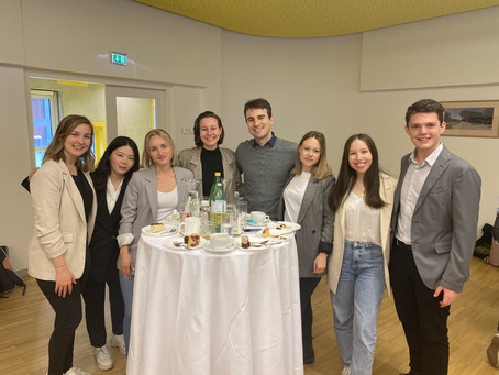 Students standing around a table at the Business Brunch