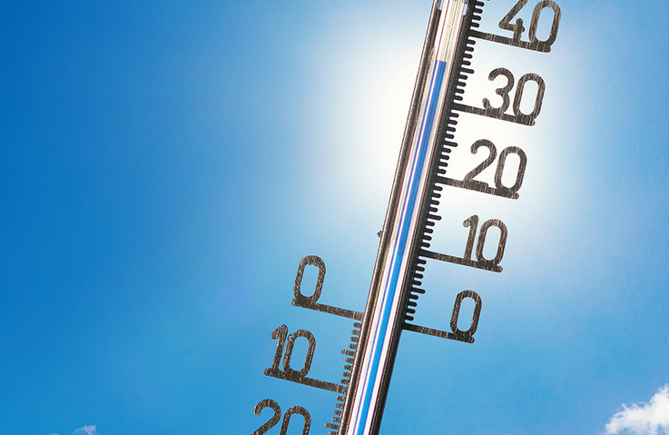 Foto eines Thermometers vor strahlend blauem Himmel