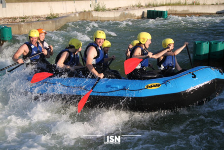 Group of young people in a rafting boat on a circuit.