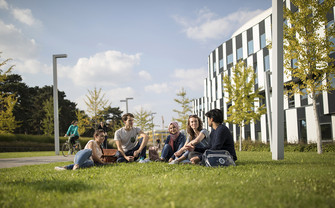 Studierende auf einer Wiese