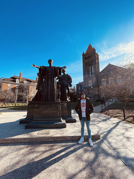 WU student Omerovic stands outside the university building and enjoys the good wheather.