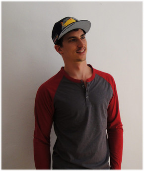 Young man in a baseball cap with a Red Bull logo on it.
