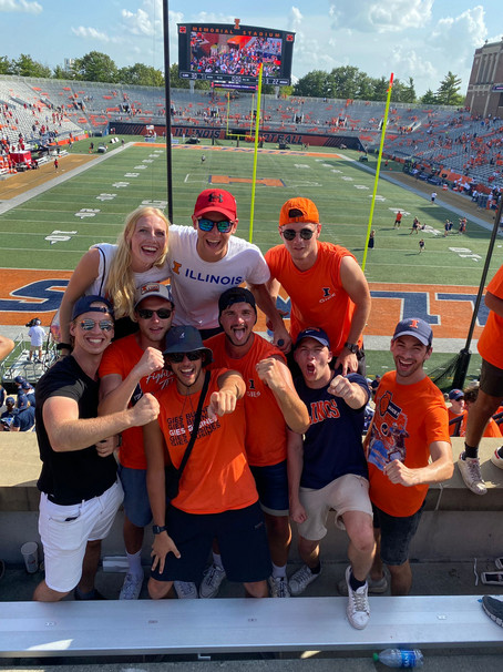 Here you see a group of people at a football match. It is obvious that they have a good time.