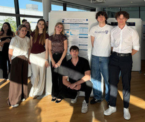 Group of students standing in front of their research poster