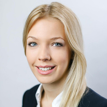 Portrait of a young woman smiling.