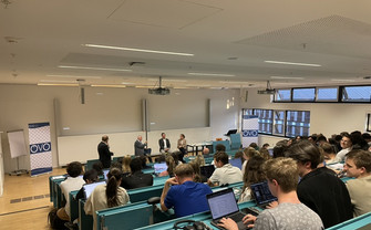 Audience listening to podium in lecture hall