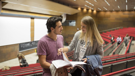 Students chatting in the lecture hall