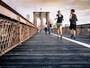 two students running on a bridge