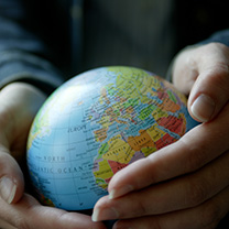2 hands hold a small globe